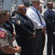 Uvalde School Police Chief Pete Arredondo, third from left, stands during a news conference outside of the Robb Elementary school in Uvalde, Texas Thursday, May 26, 2022.